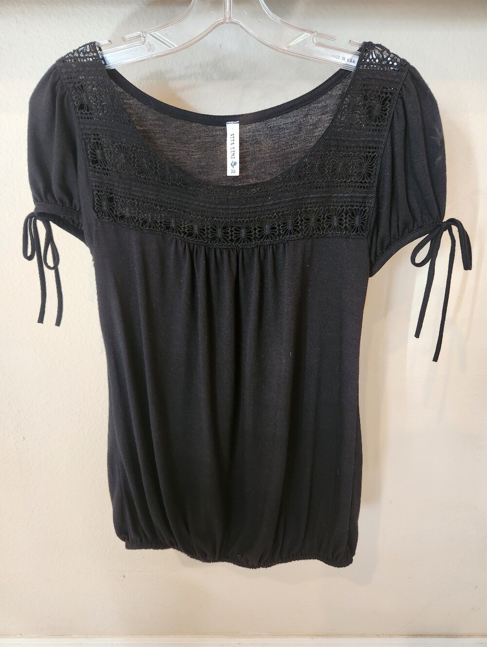 Full Tilt Soft And Cozy Flowy Black Top With Crocheted Neckline, And Bow Accents